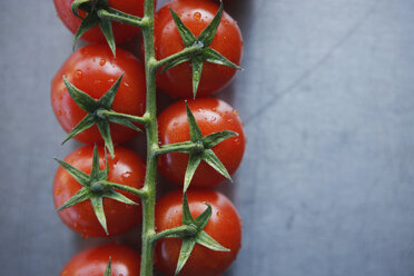 Bunch tomatoes on metal plate, elevated view, close-up - KSWF00438