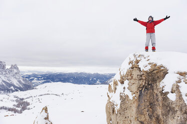 Italy, South Tyrol, Woman in winter clothes on mountain top, cheering - WESTF11342