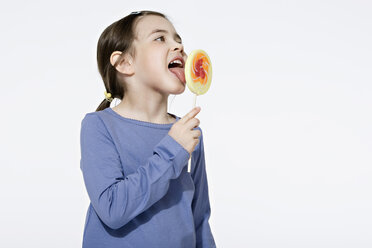 Girl (4-5) licking lollipop, portrait - LDF00605