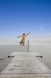 Man jumping into Lake, rear view - LDF00601