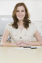 Germany, Munich, young woman in office, smiling, portrait - LDF00644