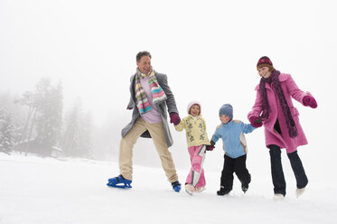 Italy, South Tyrol, Seiseralm, Family holding hands, ice skating - WEST11734