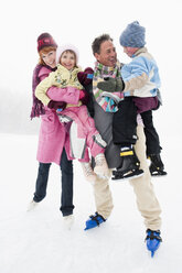 Italien, Südtirol, Seiseralm, Familie auf zugefrorenem See - WEST11732