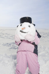 Germany, Bavaria, Munich, Child carrying snowman`s head - RBF00057