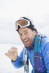 Italy, South Tyrol, Seiseralm, Man wearing ski goggles, laughing, portrait - WEST11665