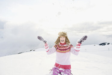 Italy, South Tyrol, Seiseralm, Woman throwing snow, portrait - WEST11656