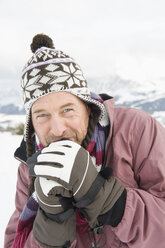 Italy, South Tyrol, Seiseralm, Man outdoors shivering from cold, portrait, close-up - WEST11611