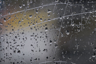 Raindrops on window pane, close-up - AWDF00347