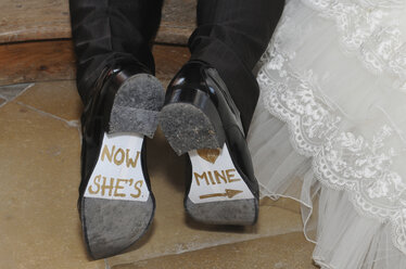 Germany, Bridal couple, Writing on shoes, close-up - AWD00338