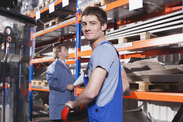 Germany, Neukirch, Apprentice and foreman in storeroom - WESTF11916