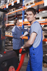 Germany, Neukirch, Apprentice and foreman in storeroom - WESTF11915