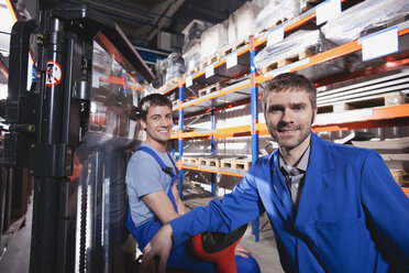 Germany, Neukirch, Apprentice and foreman in storeroom - WESTF11912