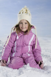 Germany, Bavaria, Munich, Girl (4-5) kneeling in snow, portrait - RBF00078