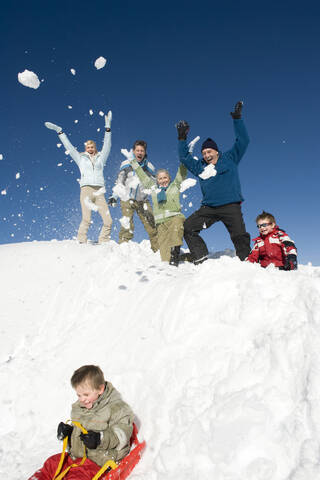 Italien, Südtirol, Seiseralm, Familie im Schnee, Spaß haben, Junge auf Schlitten, lizenzfreies Stockfoto