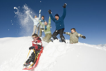 Italy, South Tyrol, Seiseralm, Family in snow, having fun - WESTF11419