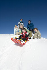 Italy, South Tyrol, Seiseralm, Family sledding - WESTF11417