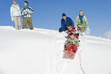 Italy, South Tyrol, Seiseralm, Family sledding - WESTF11416
