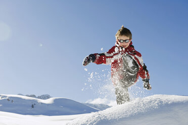 Italy, South Tyrol, Seiseralm, Boy (4-5) playing in snow - WESTF11402