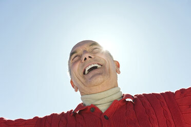 Italy, South Tyrol, Seiseralm, Senior man laughing, low angle view, portrait - WESTF11390