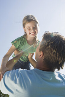 Germany, Bavaria, Munich, Father lifting daughter (6-7), smiling, portrait - CLF00749