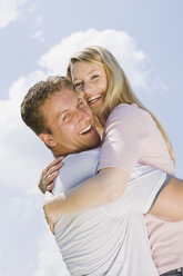 Germany, Bavaria, Munich, Young couple, man lifting woman, side view, portrait - CLF00713