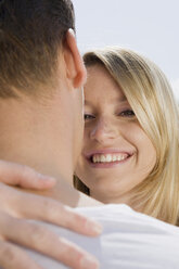 Germany, Bavaria, Munich, Young couple embracing, smiling, portrait, close-up - CLF00702