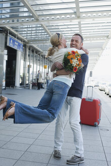 Germany, Leipzig-Halle, Airport, Couple embracing - WESTF12088