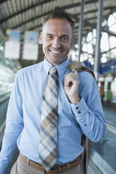 Germany, Leipzig-Halle, Airport, Businessman in Airport lounge, smiling, portrait - WESTF12018