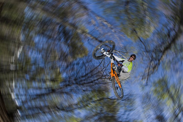 Italien, Comer See, Mountainbiker beim Sprung, Tiefblick - FFF01071