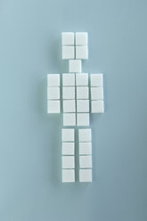 Sugar cubes arranged in shape of figurine, elevated view - ASF03923