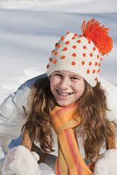 Austria, Salzburger Land, Altenmarkt, Girl (10-11) on sled, smiling, portrait - HHF03002