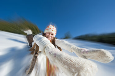 Austria, Salzburger Land, Altenmarkt, Girl (10-11) sledding, portrait - HHF03000