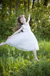 Germany, Bavaria, Girl (8-9) dancing in meadow, portrait - MAEF01795