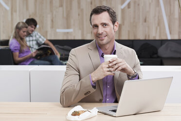 Germany, Cologne, Business man in cafe using laptop - WESTF12428