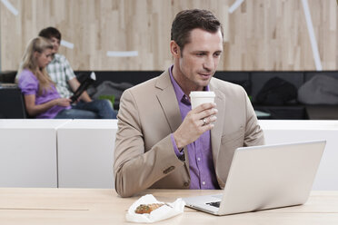 Germany, Cologne, Business man in cafe using laptop - WESTF12427