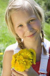 Austria, Salzkammergut, girl (10-11) holding flowers, portrait - WWF00949