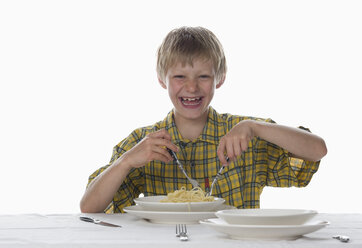 Boy (8-9) eating spaghetti, laughing, portrait - WWF00931