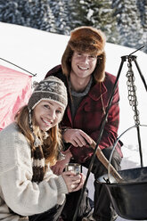 Austria, Salzburger Land, Couple cooking on campfire - HHF03044