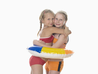 Two girls (10-11) wearing bikini, embracing, portrait - WWF01039