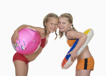 Two girls (10-11) wearing bikini standing head to head, portrait - WWF01037