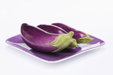 Raw Eggplants (Solanum melongena) on plate - GWF01031