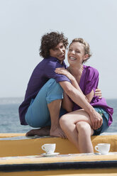 Spain, Mallorca, Couple on terrace, ocean in background - WESTF12658