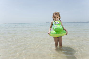 Spain, Mallorca, Girl (4-5) on the beach with inflatable - WESTF12640