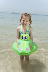 Spain, Mallorca, Girl (4-5) on the beach with inflatable - WESTF12639