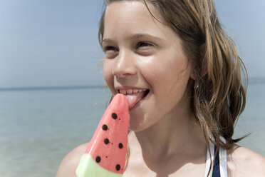 Spain, Mallorca, Girl (10-11) holding ice cream on beach, portrait - WESTF12619