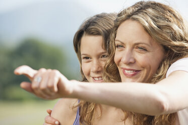 Spain, Mallorca, Mother and daughter (10-11), mother pointing, close-up - WESTF12889