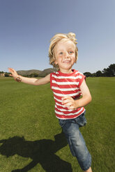 Spain, Mallorca, Boy (3-4) running across meadow - WESTF12878