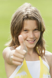 Girl (10-11) thumbs up, smiling, portrait, close-up - WESTF12867