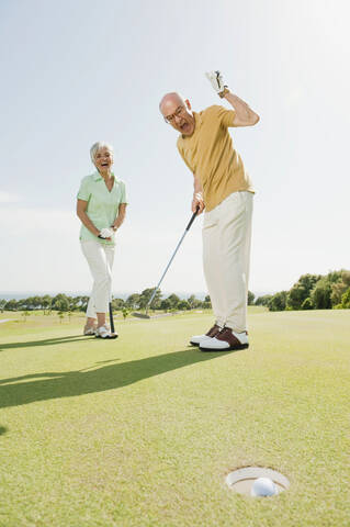 Spain, Mallorca, Senior couple on golf course, man cheering stock photo