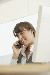 Young woman in office using telephone - WESTF12838